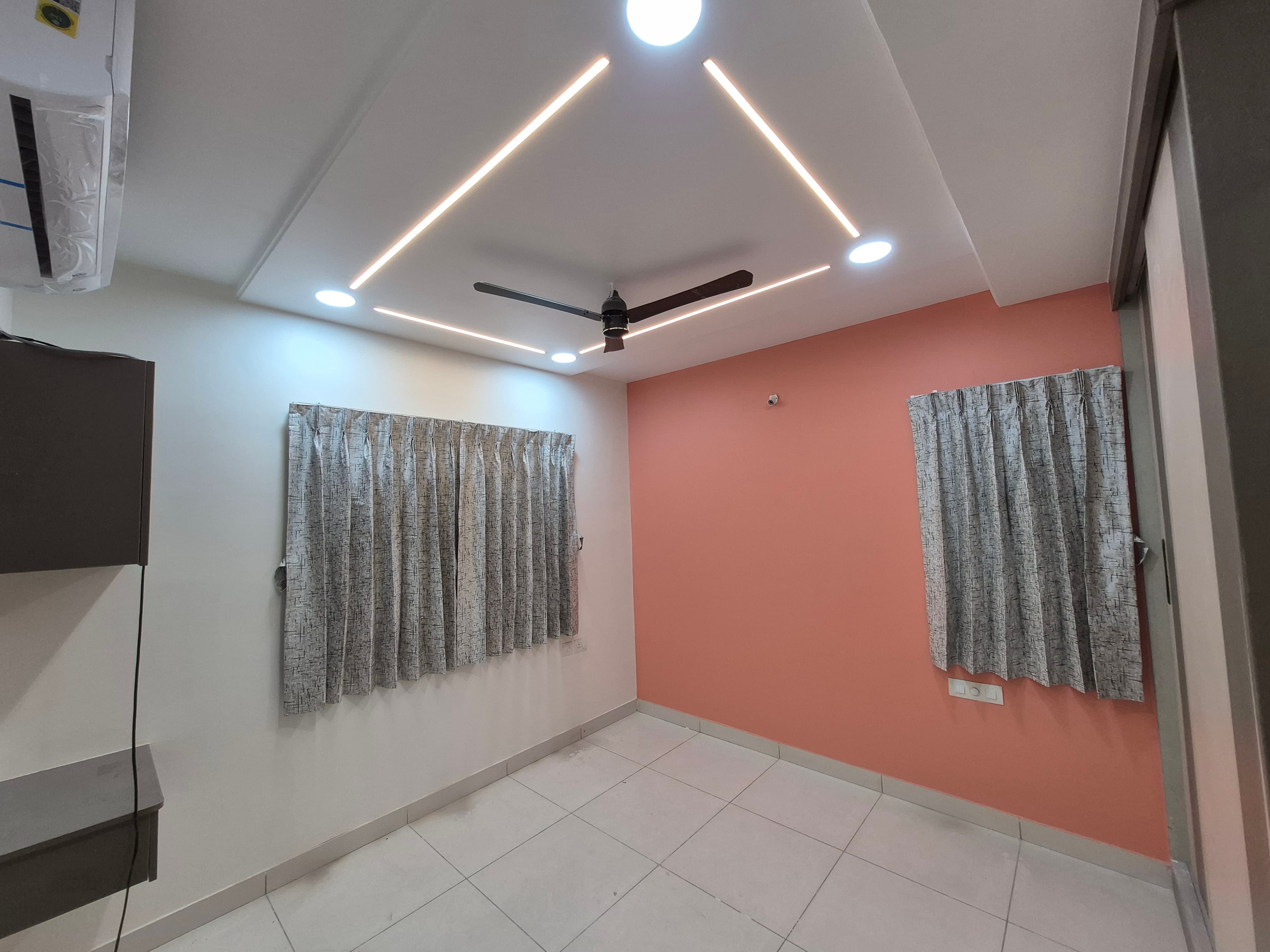 Bedroom with false ceiling detailing at Amaravati Premium Apartment