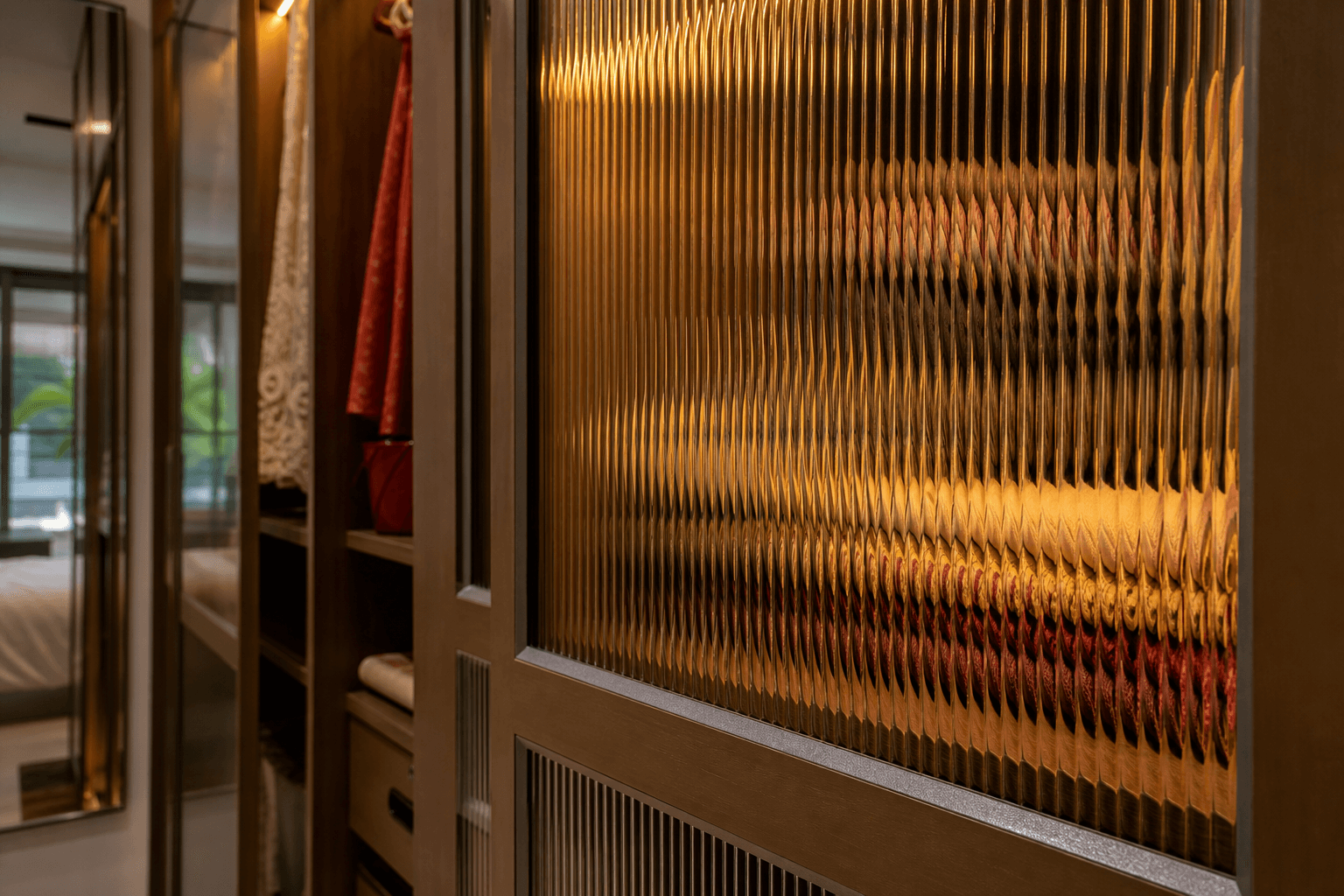 Detail shot of fluted panel wardrobe shutters with warm internal lighting in an Indian bedroom