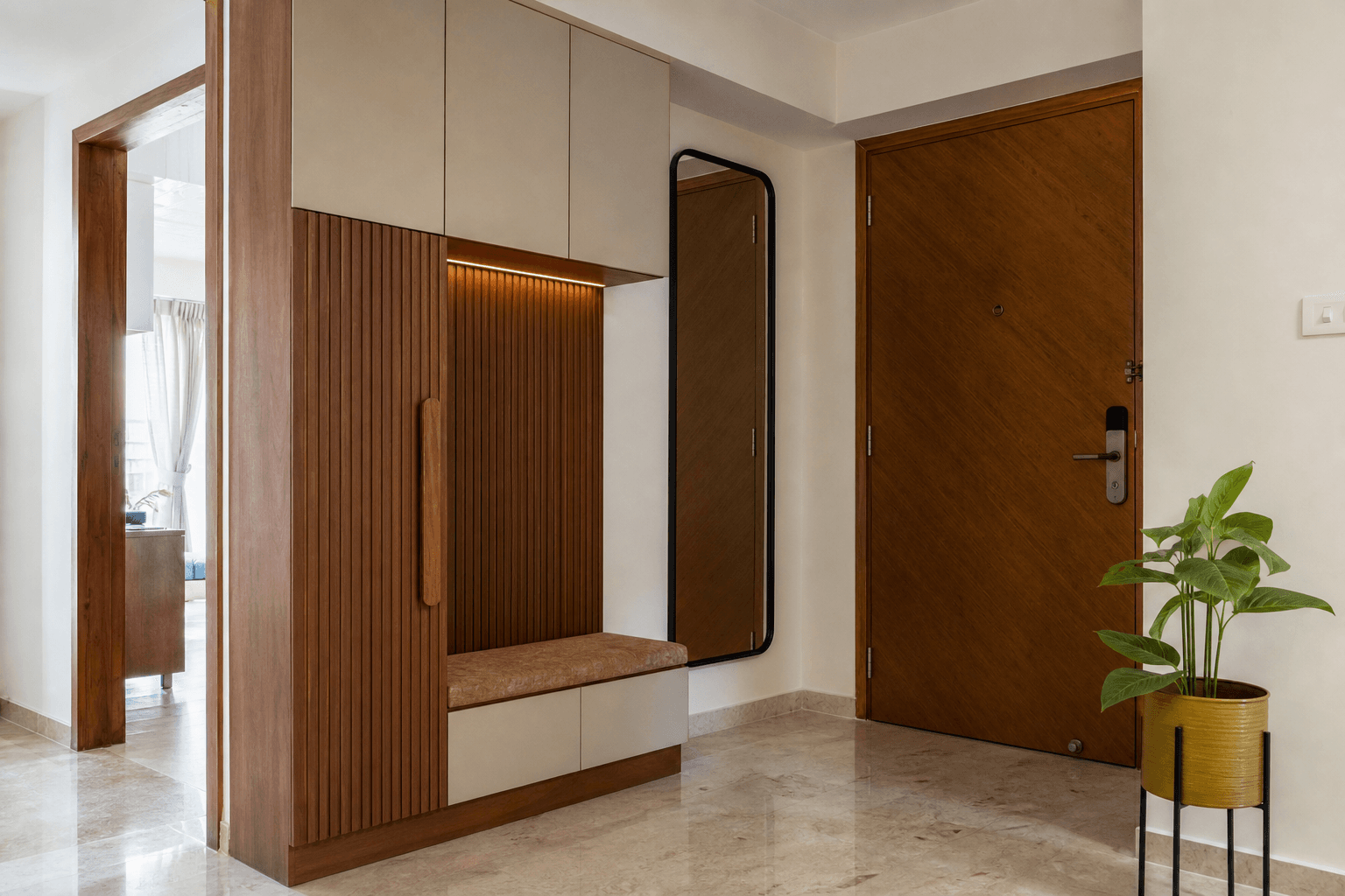 Coordinated entry foyer with storage in a modern Indian apartment home