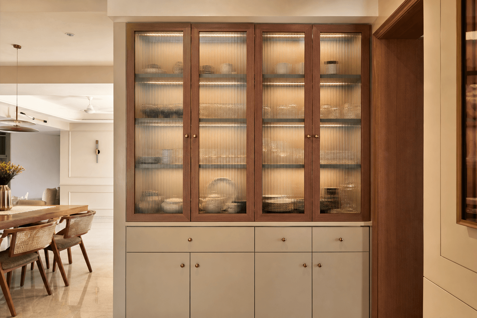 Custom crockery display unit with fluted glass in an Indian dining space