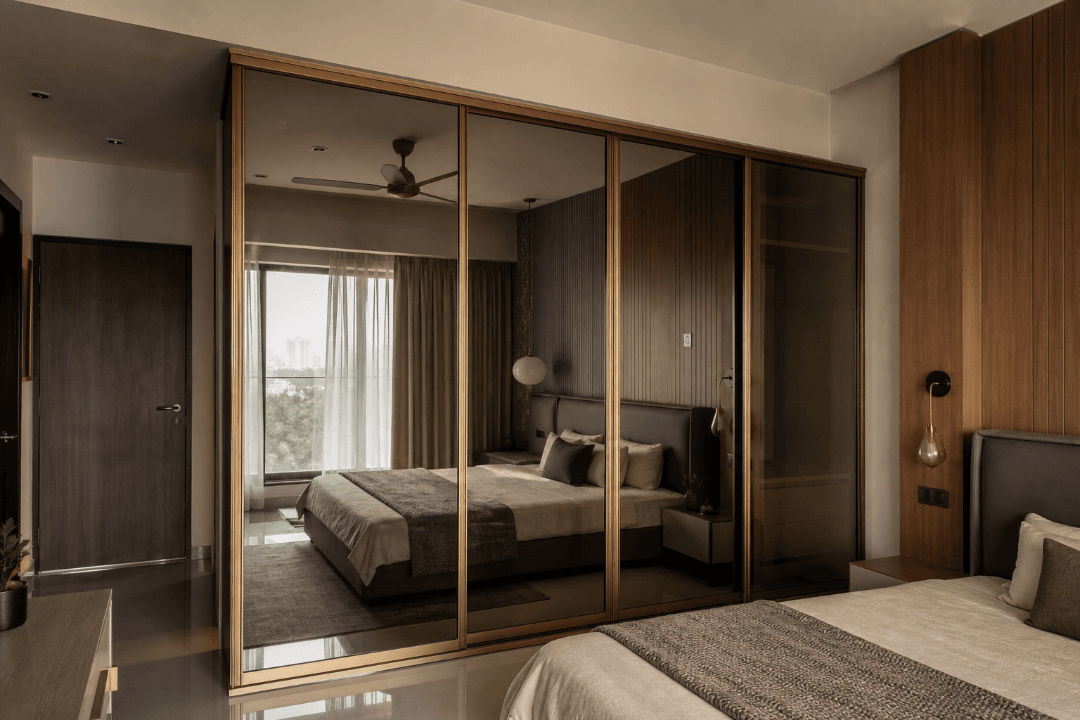 Floor-to-ceiling sliding wardrobe with mirror panels in an Indian master bedroom
